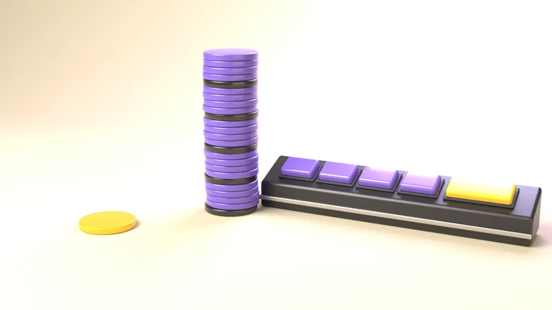 Ein Turm aus 25 violetten und schwarzen Spielchips neben einem einzelnen gelben Chip, rechts das Tastenfeld eines Automaten.